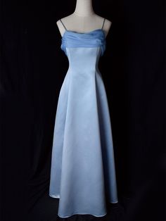 Step into timeless elegance with this Vintage Blue Satin Gown. Crafted from luxurious satin, this dress features delicate spaghetti straps that provide a graceful and feminine silhouette. The highlight of this gown is its unique winged back design, adding a touch of whimsy and sophistication. Perfect for formal occasions, evening events, or any special celebration, this elegant dress ensures you'll make a stunning entrance. The vintage blue hue adds a classic touch, making it a versatile additio