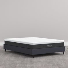 an image of a mattress that is in the middle of a room with gray carpet