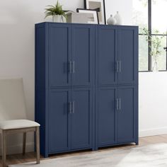 a large blue cabinet sitting next to a white chair