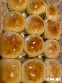 some bread rolls are in a bowl on a table