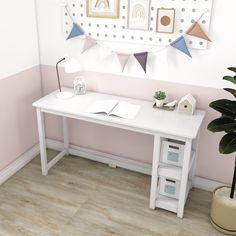 there is a white desk in the corner of this room with pink and white walls