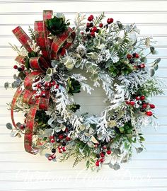 a christmas wreath hanging on the side of a building