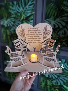 a person holding up a card with a lit candle in front of it and the words artful craftsmead written on it