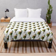 a green leafy pattern on a white background throw blanket