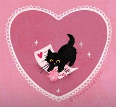 a black cat is sitting in the middle of a heart