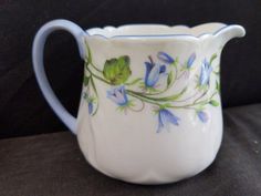 a white pitcher with blue flowers painted on it