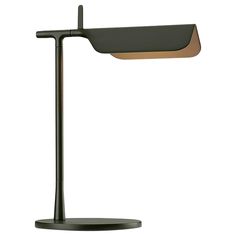 a desk lamp with a black base and a brown shade on the top of it