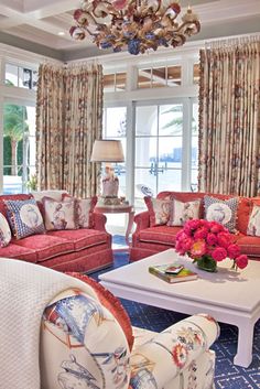 a living room filled with furniture and a chandelier