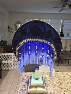 an elaborately decorated table with blue and white decorations on it's side, in a living room