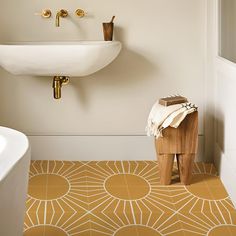 a white sink sitting next to a wooden stool in a bathroom