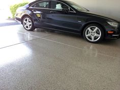 a black car is parked in a garage