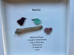 two birds sitting on top of a piece of driftwood in a frame with the words bestie written below