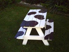 a picnic table made out of pallet boards with black and white polka dots on it