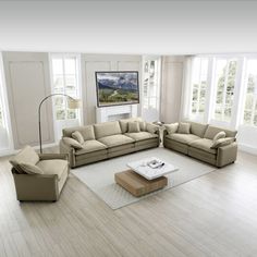 a living room filled with lots of furniture in front of a flat screen tv mounted on the wall