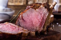 a piece of meat sitting on top of a wooden cutting board