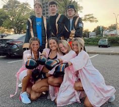 a group of young people standing next to each other in the street wearing boxing gloves