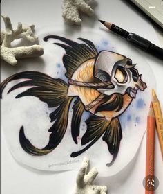 a drawing of a fish on a plate next to some crayon pencils