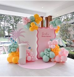 this is an image of a birthday party with balloons on the wall and palm trees in the background