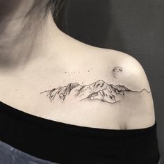 a woman with a mountain tattoo on her chest