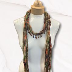 This Is part of Ciao Bella Jewelry's Vecchio Mondo 'Old World Collection" made with a unique yarn combination of Italian yarns. Perfect accessory for your wardrobe. Makes a great gift!! Orange brown and olive in color Comes in linen pouch with artist card. Handmade Bohemian Yarn Jewelry, Handmade Multicolor Jewelry For Fall, Multicolor Hand Knotted Beaded Necklace As Gift, Handmade Bohemian Jewelry For Fall, Linen Pouch, Beaded Scarf, Mohair Scarf, Unique Yarn, Artist Card