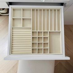 an open drawer with several compartments in it