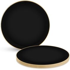 two black plates with gold rims sitting side by side