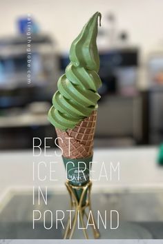 an ice cream cone with green icing on top and the words best ice cream in portland above it