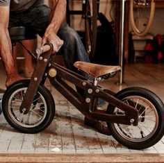 a man is working on a wooden bike