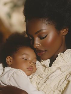 a woman is holding a baby in her arms and looking down at the child's face