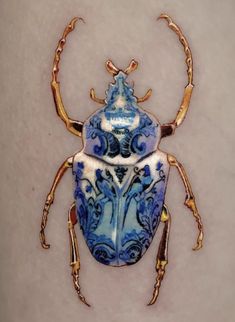 a blue and white bug sitting on top of a table