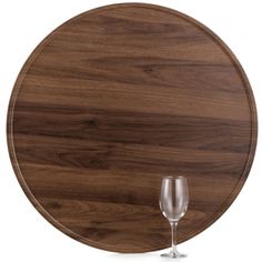 a wine glass sitting on top of a wooden plate