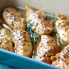 the chicken is cooked and ready to be served in the casserole dish with rosemary sprigs on top