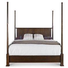 a bed with four posts and pillows on the top of it, against a white background