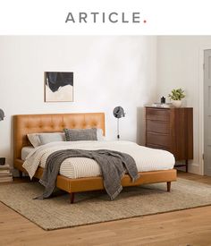 a bed sitting on top of a wooden floor in a bedroom