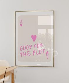 a pink poster with the words good for the plot on it in front of a dining room table