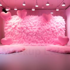 a pink room with lots of hearts on the wall and fluffy rugs in front of it