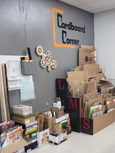 cardboard boxes are stacked on top of each other in front of a sign that says cardboard corner