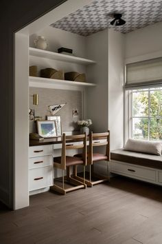 a bedroom with a bed, desk and window in the corner next to a book shelf