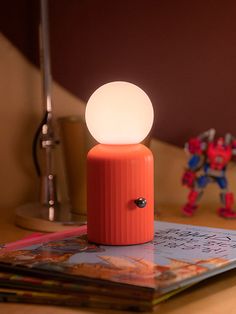 Versatile lighting! ✨ A totally unique design that takes inspiration from Lund's iconic Skittle bottle! The silicone bulb has 8 color settings and it's wireless so can easily be used anywhere. With a wireless phone charger included, this is the perfect bedside duo. Wireless. Charge the lamp with a wireless charger or color-changing bulbs with a micro USB cable. Dimmer switch to adjust brightness. Silicone nonslip base. Wireless phone charger included. Up to 14 hours of battery life from a single Cool Unique Lamps, Counter Lamp Kitchen, Beachy Bedrooms, Fun Lamps, Dopamine Design, Wireless Lamp, Floating Lamp, Mcm Lamp, Fun Lamp