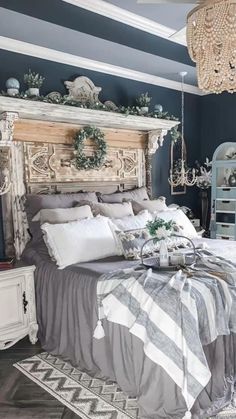 a large bed sitting in a bedroom next to a chandelier