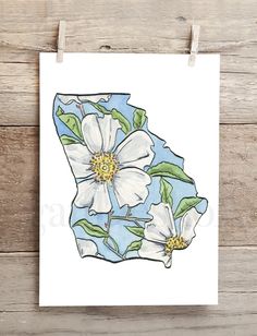 a white flower with green leaves on a blue and white background is hanging from a clothes line