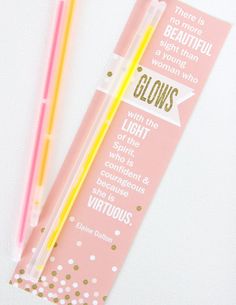 two yellow and pink toothbrushes sitting next to each other on a white surface