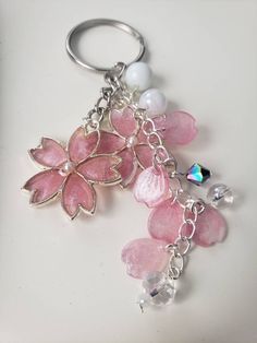 a key chain with pink flowers and pearls