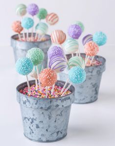 there are many candy lollipops in the pot on the table and one has sprinkles