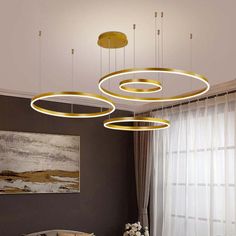 three circular lights hanging from the ceiling in a living room