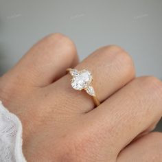 a woman's hand with a diamond ring on it