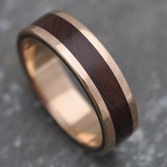 a wedding ring with wood inlays on it