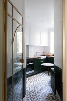 a kitchen with green cabinets and white walls