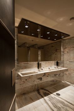 a large bathroom with two sinks and mirrors