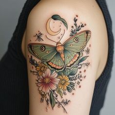 a woman's shoulder with a butterfly and flowers tattoo on her left side arm